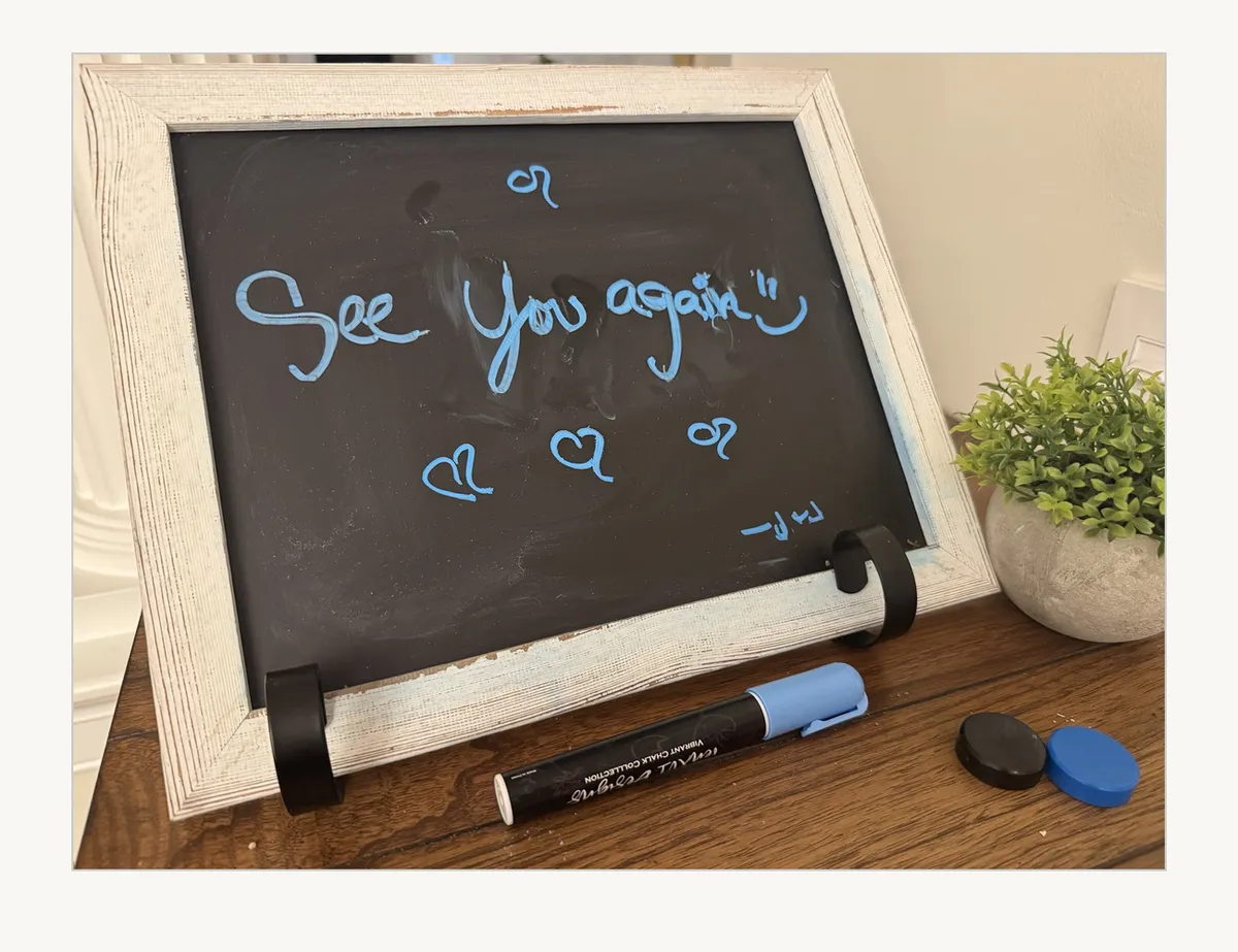 A small chalkboard by the door with