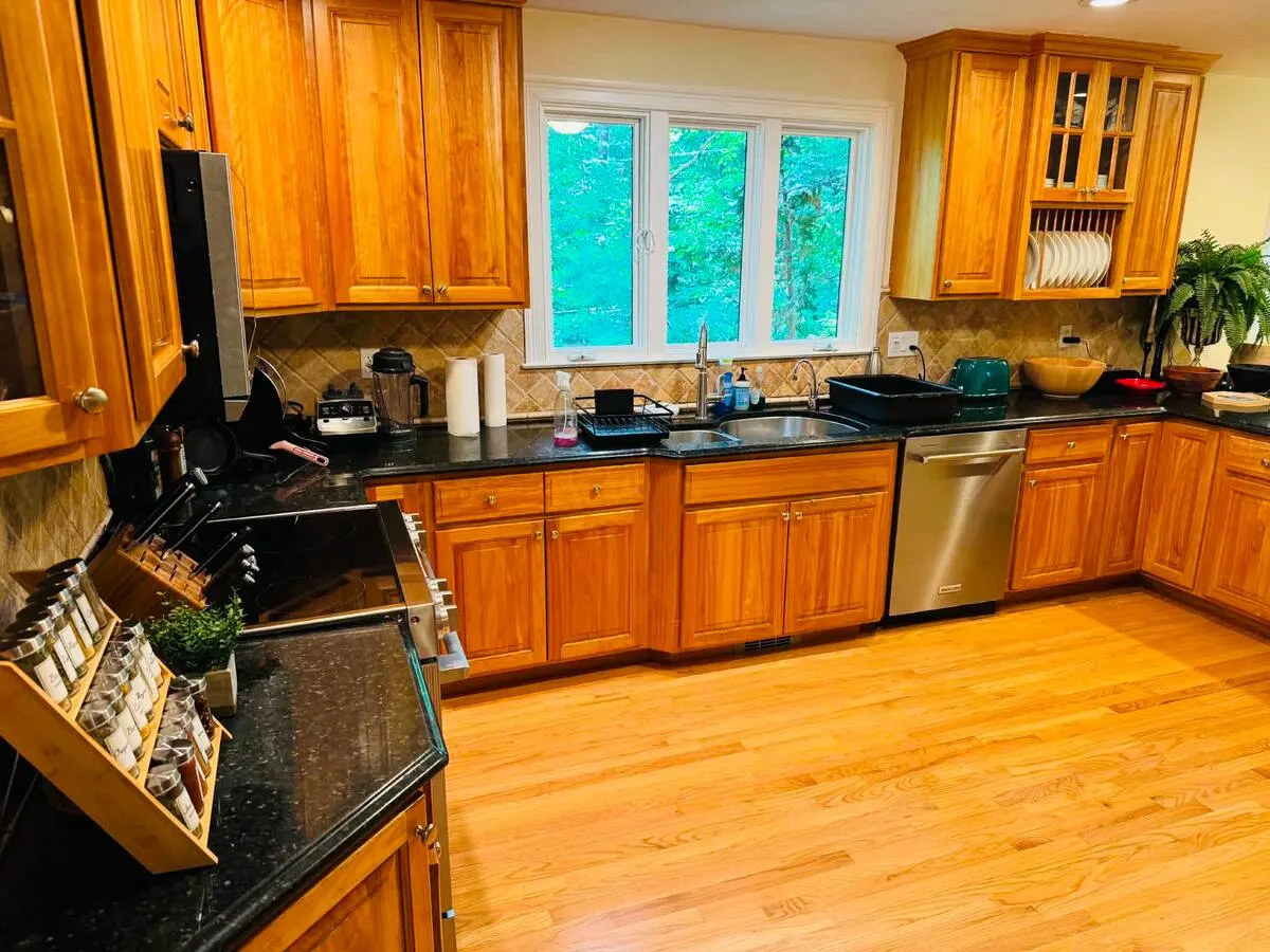 Warm wood chef's kitchen in Southborough with a pull-out spice rack